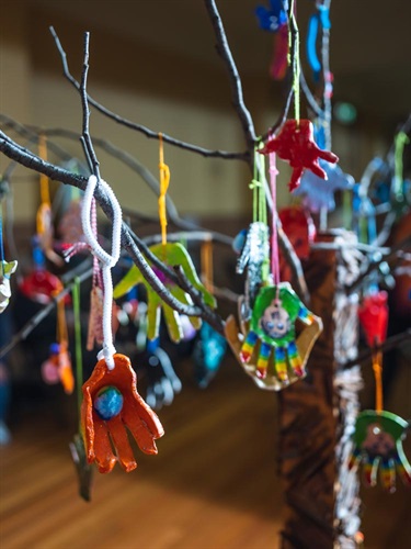 Possability – clay hands hanging on branches of a tree without foliage